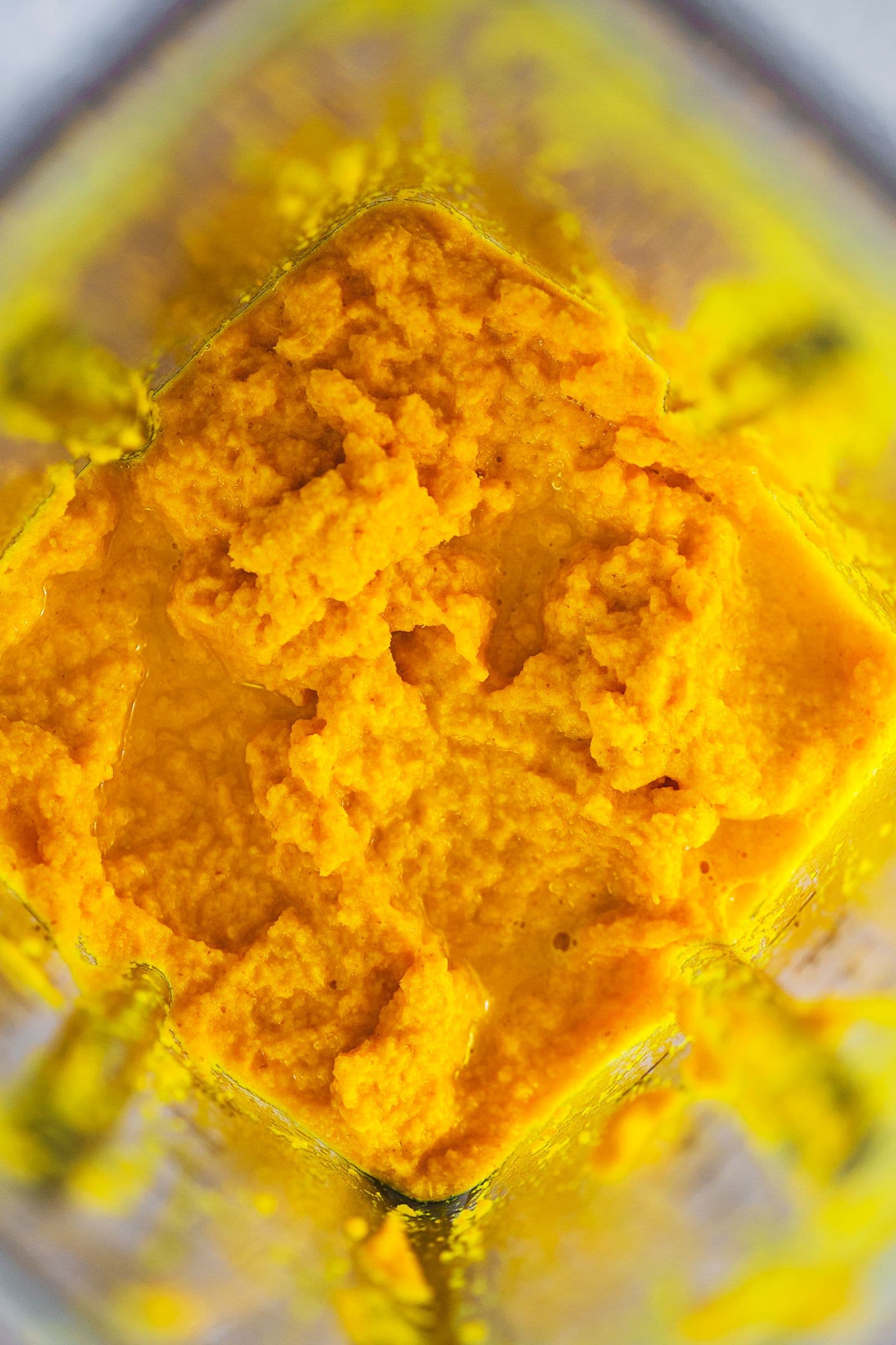 Smooth, bright orange turmeric and ginger mixture freshly blended.