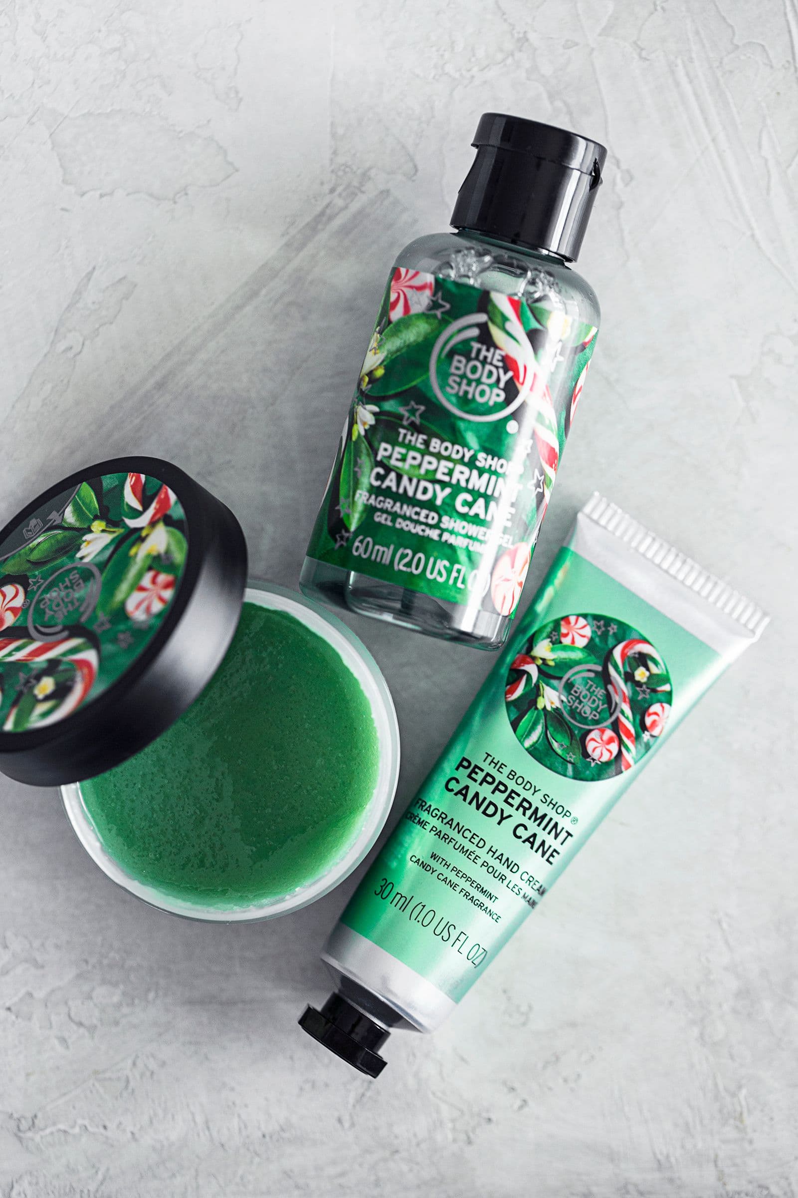Limited edition The Body Shop products with mint candy cane fragrance arranged on a flat surface.