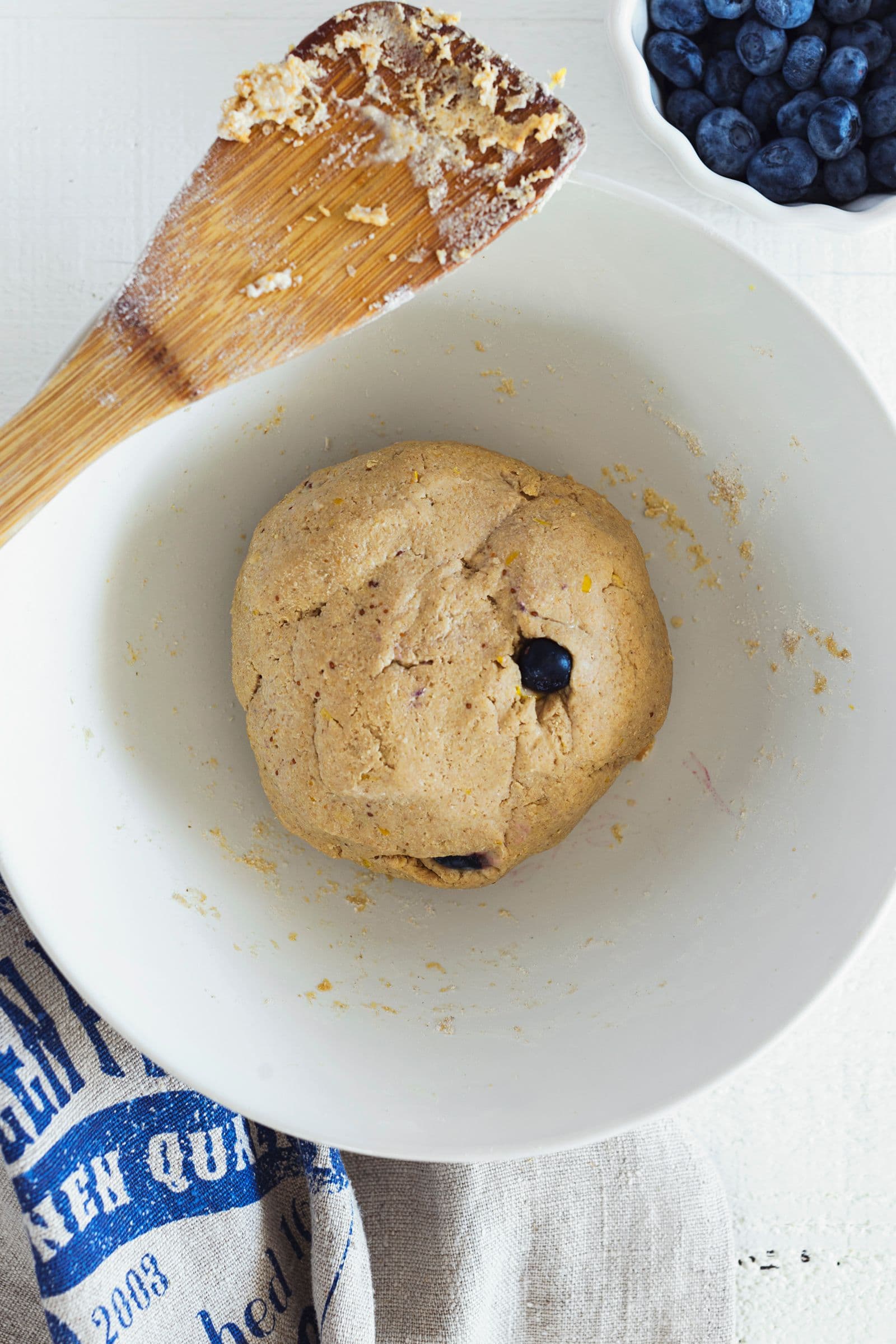 Vegan scone dough shaped into a ball before rolling and slicing.