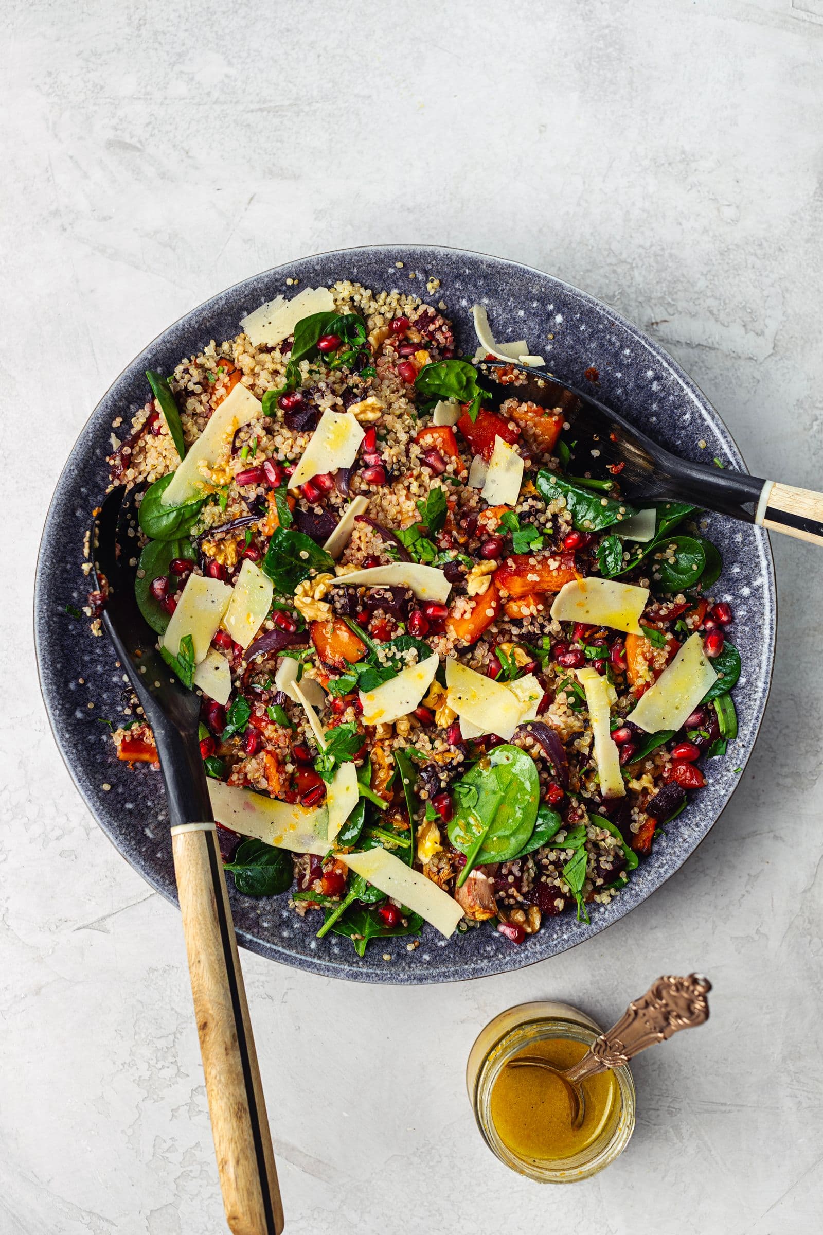 Winter salad served in a bowl with citrus vinaigrette on the side.