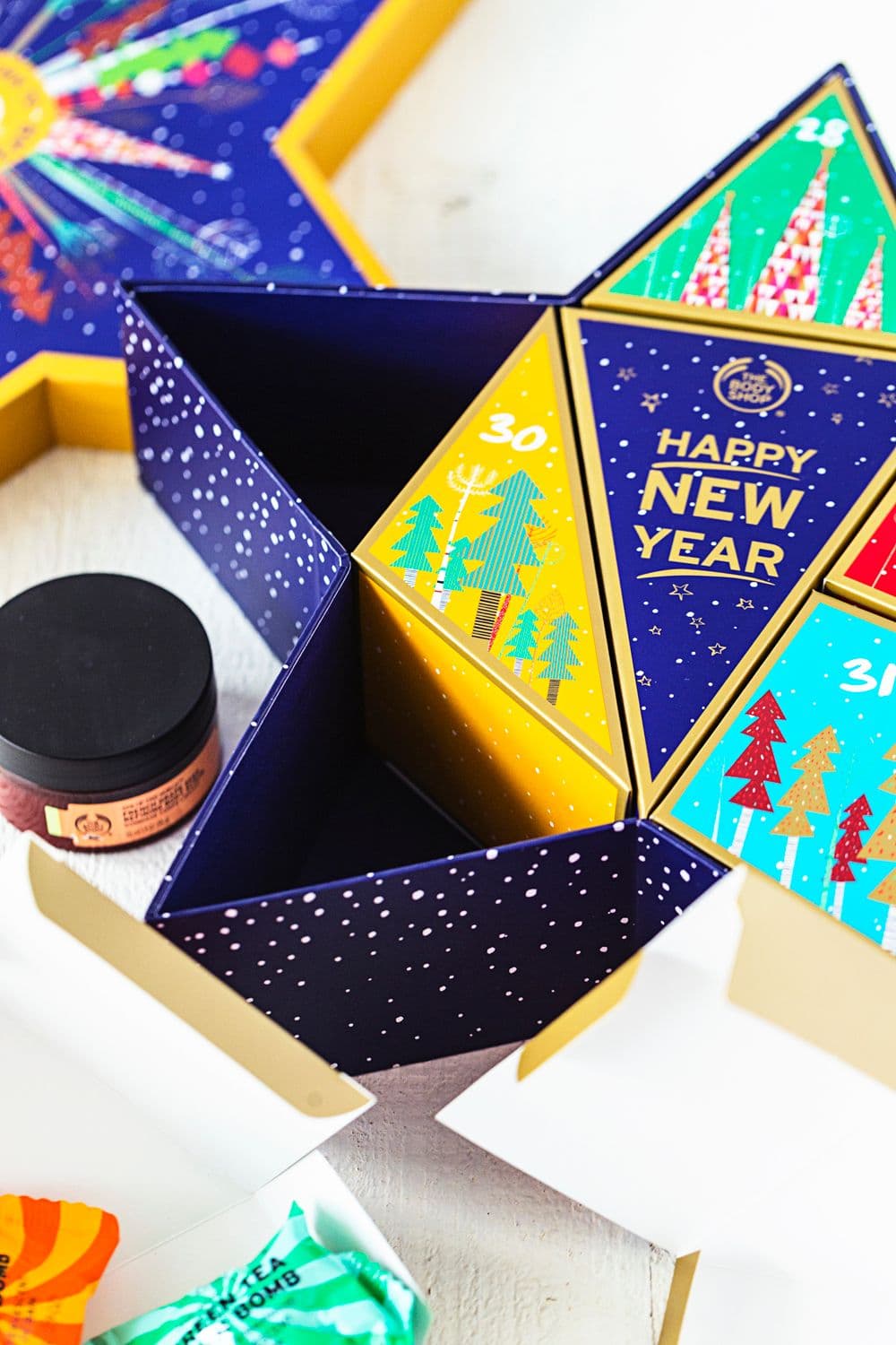 Festive The Body Shop packaging featuring numbered sections and colourful body care items inside.