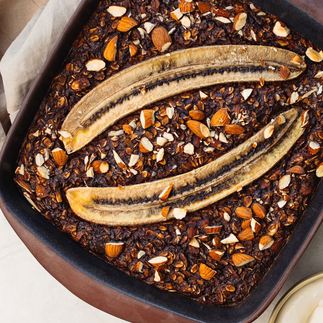 Rich vegan baked oatmeal with chocolate, banana and crunchy almonds.