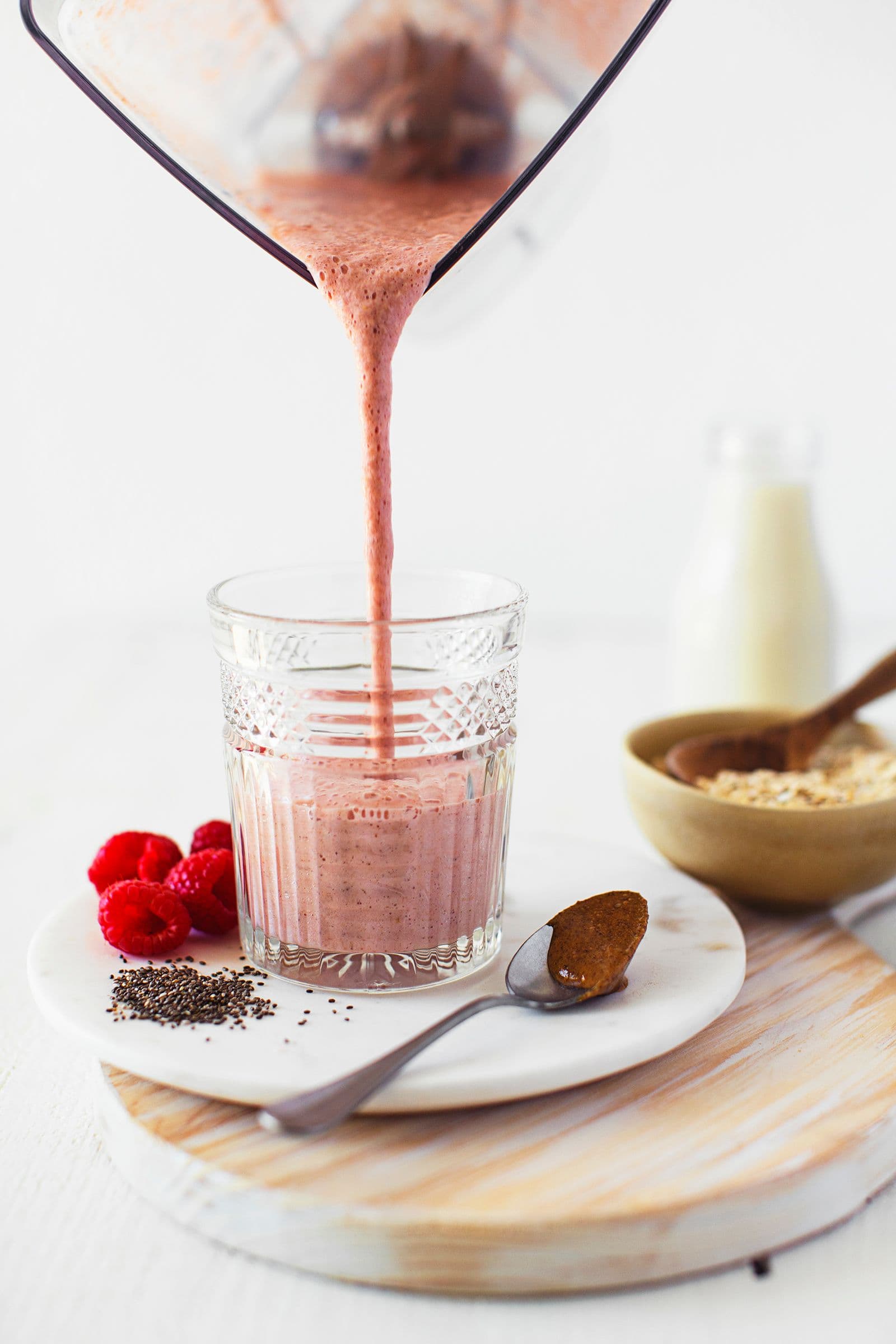 Freshly blended hormone balancing smoothie being poured into a glass.
